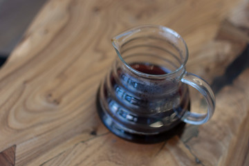 Bruch chemex coffeemaker cup of coffee. Black espresso, wooden texture background table