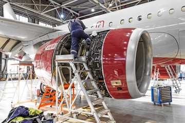 Aviation industry, mechanic repairs aircraft engine jet