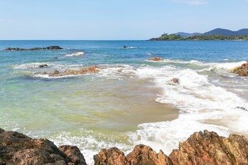 Sea surf, rocks and white foam.
