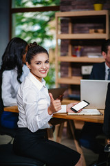 Fototapeta premium Beautiful businesswoman show big thumb at the meeting.