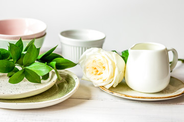 ceramic tableware with flowers on white background