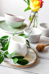 ceramic tableware with flowers on white background