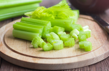 fresh celery sliced on wooden background