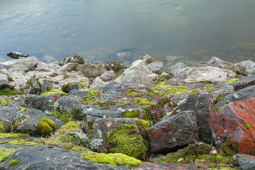 Big stones are on the lake shore in Finland at summer.