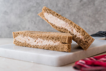Triangle Light Sandwich with Tuna Fish Paste on Marble Board.