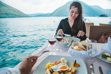 couple eating in restaurant at seaside. romantic date