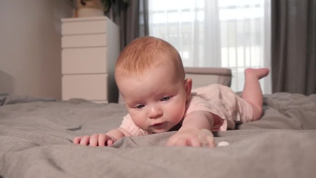 Cute little Baby Girl Portrait lying on a Bed at Home - Day