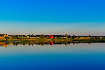 Fototapeta na wymiar russian village on the lake in the summer evening