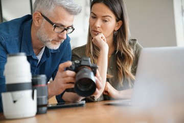 Photographers in office checking on picture shots