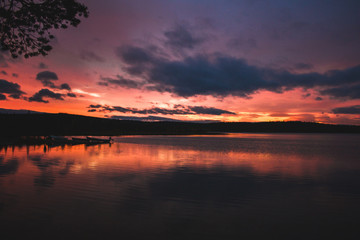 Fototapeta na wymiar Deep orange sunset on Finnish lake