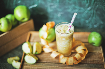 Green smoothies on a dark background. Apple and kiwi smoothies. Healthy eating concept close up and copy space.