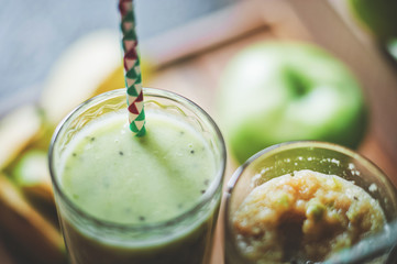 Green smoothies on a dark background. Apple and kiwi smoothies. Healthy eating concept close up and copy space.