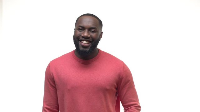 Slow motion charismatic happy funny african american bearded guy hold laugh smiling joyfully, covering mouth chuckling making fun of friend, pranking, joking, giggling mocking, white background