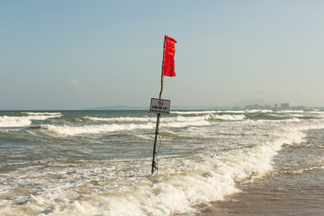 Red warning flag on the beach of Vietnam