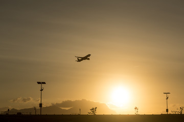 Fototapeta na wymiar Silhouette takeoff plane from the airport while sunset