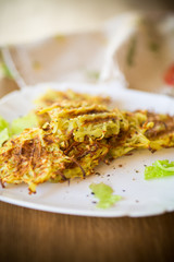 grilled potato pancakes in a plate, on a wooden table