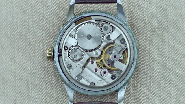 Old vintage clock mechanism working, closeup shot with soft focus. 4k. Vintage Watch Gears Movement Macro. Close up of a internal clock mechanism.