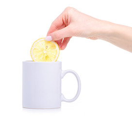 Slice lemon put in white cup mug of tea on white background isolation