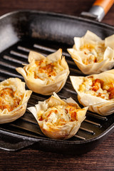 French cuisine concept. Mini cake Kish from pumpkin and goat cheese with filo dough. Cupcake baking dish. European appetizer to white wine. Top view, copy space