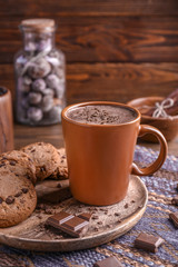 Cup with tasty coffee on table