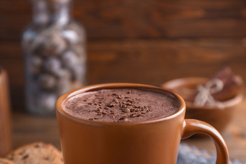 Cup with tasty coffee on table
