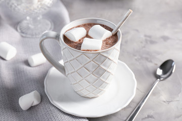 Cup with tasty coffee on table