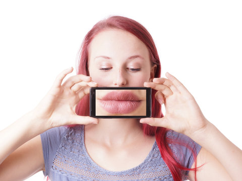 young woman messing around with camera phone taking picture of her own lips