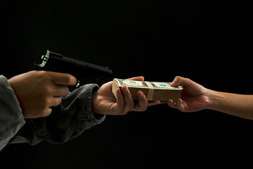 Man carrying a gun to rob the money. The bad man hold gun to rob in the bank. Thief or robber in...