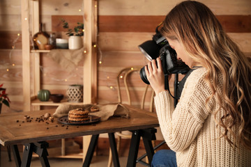 Female food photographer working in home studio