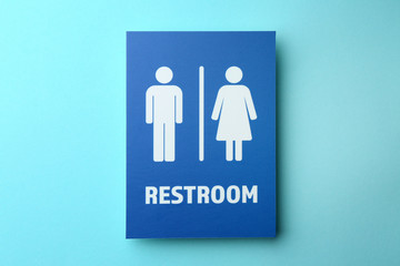 Unisex restroom sign board on color background. Concept of transgender