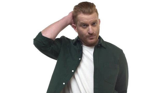 Slow motion handsome clueless redhead caucasian masculine man scratching back head thoughtful, thinking, looking unsure doubtful, hesitating, cannot figure out, posing uncertain white background