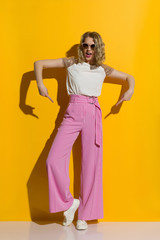 Woman Is Pointing At Her Striped Wide Legs Trousers And Talking