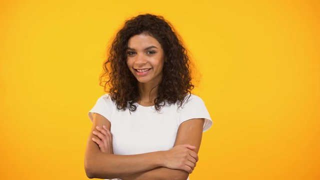 Joyful african american millennial pointing at camera, hey you gesture, flirt