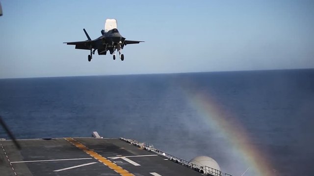 US Navy jet landing on aircraft carrier