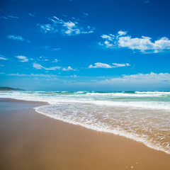 Yellow sand beach, sea and deep blue sky.