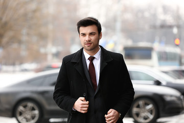 Portrait of handsome young businessman outdoors