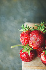Natural texture of ripe red strawberries close-up and copy space. Strawberries on a dark background, the concept of healthy food, toned photo