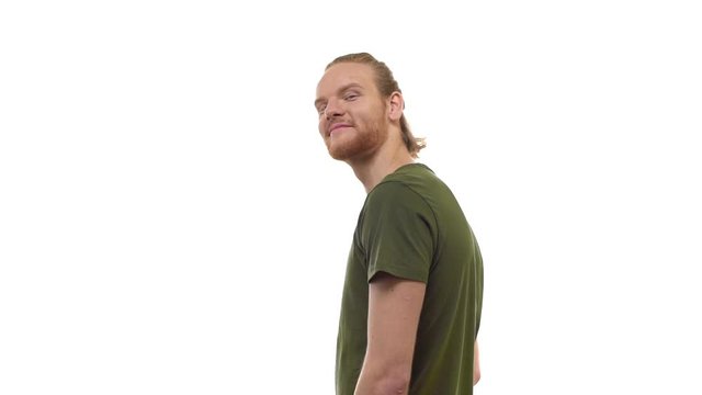 Slowmo back view handsome bearded ginger young guy turning camera inviting joing come with him, smiling friendly, call friend pointing head direction time go together, standing white background