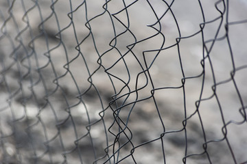 Damaged metal mesh fence