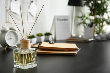 Reed diffuser on table in room