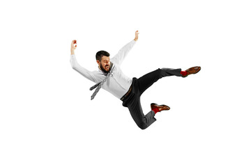Full length shot of a young businessman playing football isolated on white background.