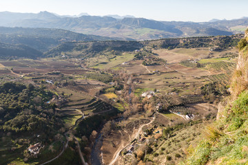 Fototapeta na wymiar Sierra de Ronda, fields and mountains from the edges of steep cliffs in Ronda, Spain