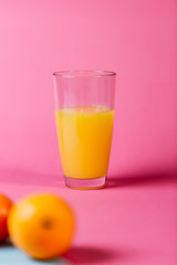 Orange juice photographed on colorful background.