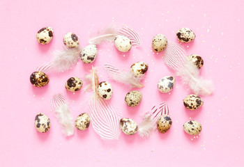  Pattern with quail eggs and  feathers on pink  background.