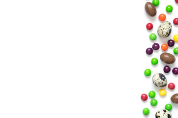  Easter eggs, multicolored sweets , white  background.  Concept of celebrating Easter, Easter decorations. Flat lay, top view. Copy Space.