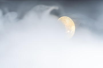 Golden bitcoins with smoke on black background. Business concept. Internet security and protection concept.