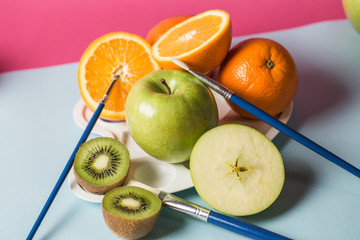 Different kinds of fruit photographed on colorful background.