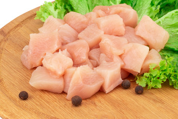 Raw chicken breast fillets on wooden cutting board