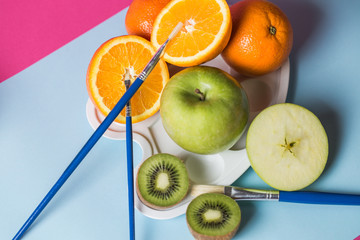 Different kinds of fruit photographed on colorful background.