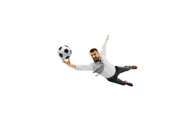 Full length shot of a young businessman playing football isolated on white background.